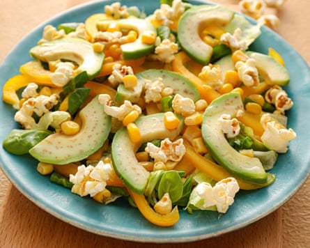 Plate with avocado, pepper and popcorn