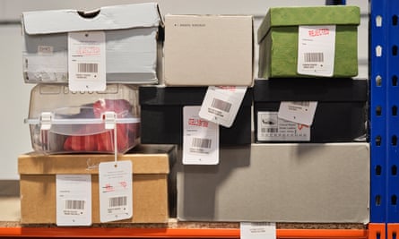 At the Vestiaire Collective warehouse in Crawley, UK, boxes marked with red “rejected” labels contain fashion items authenticators decide are fake