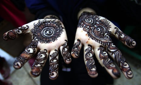 Close up of henna tattoo drying on a girl's hands.
