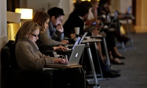 People work on laptops at the British Library in London