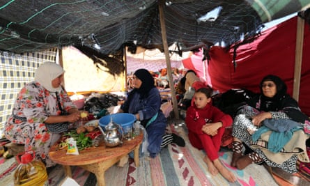Women taking shelter under a makeshift tent in Moulay Brahim.