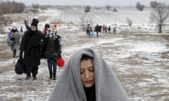 Migrants walk through a frozen field after crossing the border from Macedonia, near the village of Miratovac, Serbia.