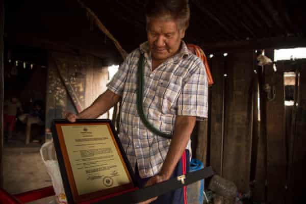 Mateo Sobode Chiqueno displays a plaque given to him in November 2021 by Paraguay’s senate in recognition of his work