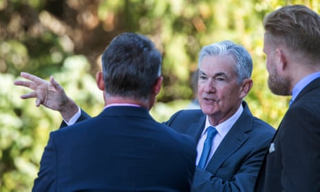 The chair of the Federal Reserve, Jerome Powell, centre, talks with attendees at the annual symposium in Grand Teton national park last year.