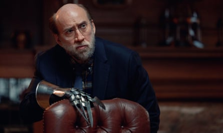 Nicolas Cage behind a leather chair in a film still