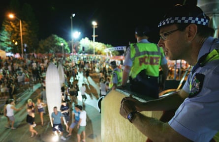 The 1% tend to holiday elsewhere … police watch over the Schoolies celebrations.