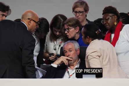 André Corrêa do Lago sits as Simon Stiell, UN climate chief, left, speaks with other UN officials during a plenary session