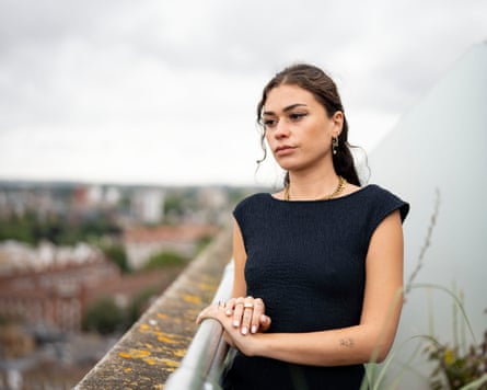 A woman looking sad on a balcony