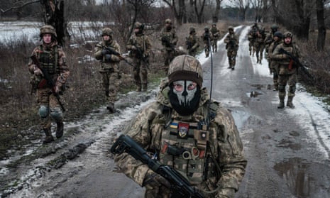 Ukrainian servicemen walk on the road toward their base near the frontline in the Donetsk region on February 4, 2023.