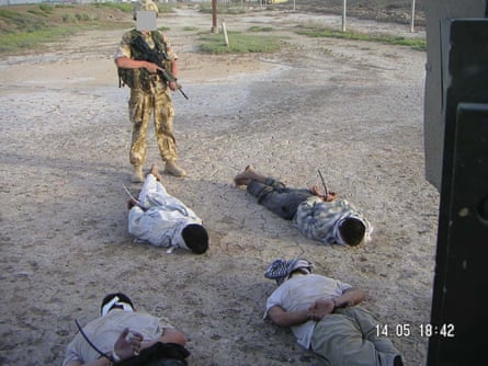 An image of Iraqi detainees guarded by a British soldier shown at the al-Sweady inquiry.