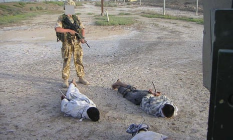 Detained Iraqis being guarded by a British soldier that was shown at the Al-Sweady Inquiry iinto claims that British troops killed and tortured Iraqi civilians.