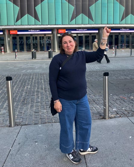 Alessandra Fossati holds up her wrist to show off a Radiohead tattoo