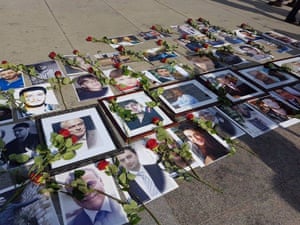 Photographs of missing relatives on the pavement at the Families for Freedom protest at the Syria peace talks in Geneva.