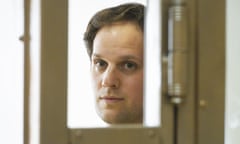 Wall Street Journal reporter Evan Gershkovich stands in a glass cage in a Moscow courtroom in June.