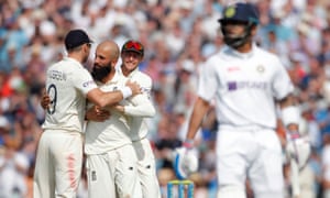 Moeen Ali celebrates with James Anderson after taking the wicket of India’s Virat Kohli