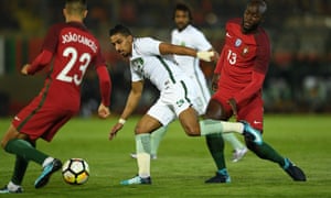 Saudi Arabia’s Salem al-Dawsari tries to avoid the challenges of Portugal’s João Cancelo, left, and Danilo Pereira.