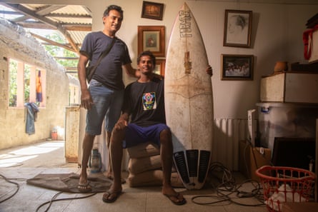James Kusitino stands in his home with his father, James Snr.