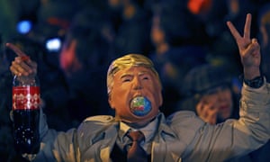 A person wears a Donald Trump mask during the ‘March for Climate’ demanding action against climate change during the COP25 Climate Summit in Madrid, Spain, in December 2019.