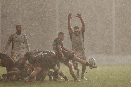 Charlie Chapman of Exeter Chiefs kicks upfield from a scrum in the driving rain