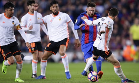 Barcelona’s Lionel Messi weaves through the Valencia defence during the 4-2 win on Sunday.