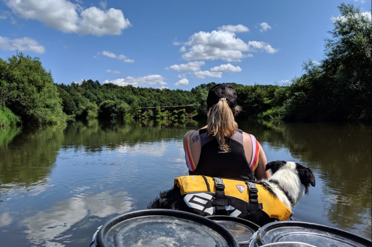 A woman and her dog canoeing on River Severn
