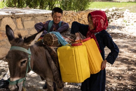 Children collecting water in rural Bamyan. The humanitarian crisis has caused almost every household to live below the poverty line since the Taliban takeover.