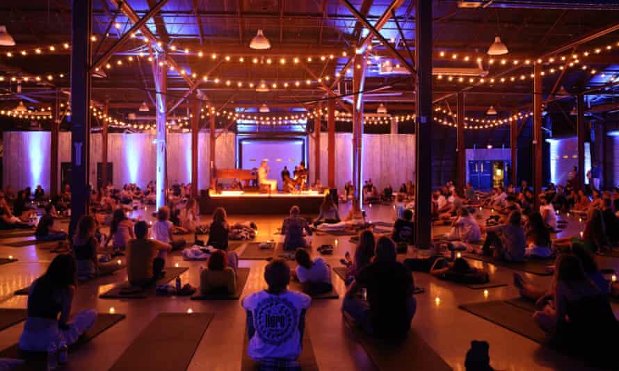 East Forest and Jon Hopkins on stage in Austin, surrounded by people on yoga mats