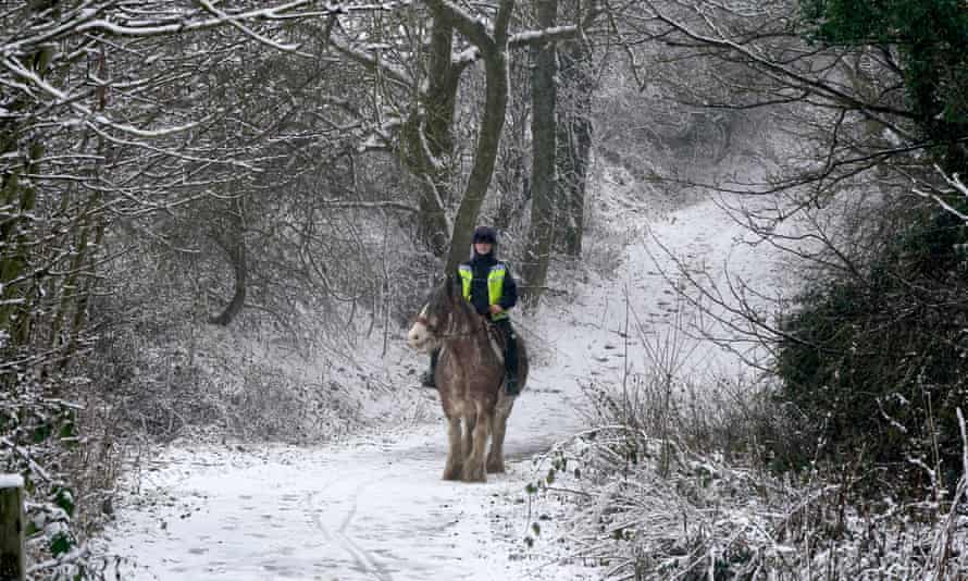 A woman rides a horse through the snow near Castleside, County Durham