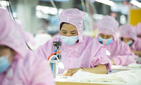 Workers producing face masks at a factory in Haian in China's eastern Jiangsu province