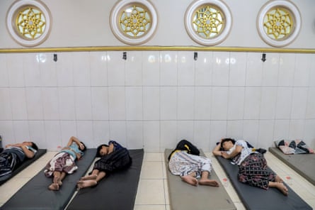 Students suffering from food poisoning receive medical treatment inside a mosque on the premises of the Manbaul Hikam Islamic boarding school in Sidoarjo, East Java province, Indonesia
