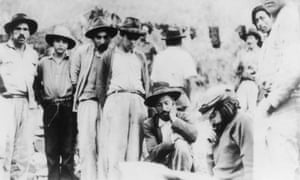 The last photo of Che Guevara alive, taken a few weeks before his death. Guevara, seated at right, studies a map of the Pesca river region.