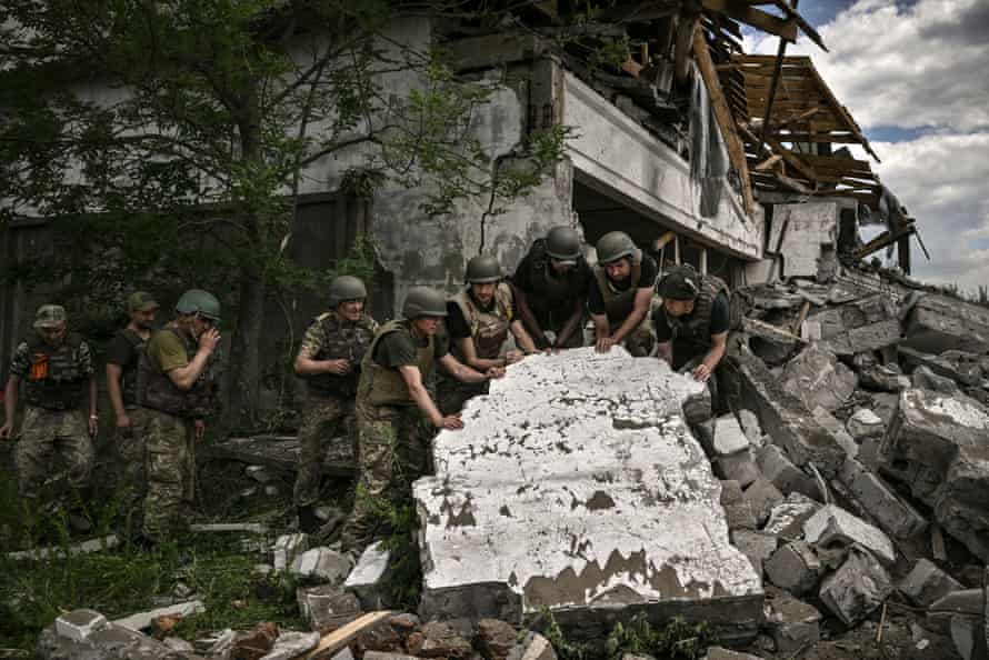 Ukrainian soldiers inspect a destroyed warehouse reportedly targeted by Russian troops on outskirts of Lysychansk, in the eastern Ukrainian region of Donbas.