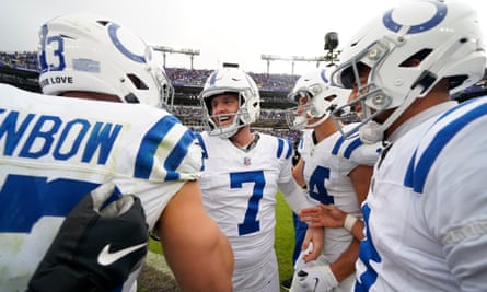 Matt Gay celebrates with teammates after kicking the winning field goal against the Ravens