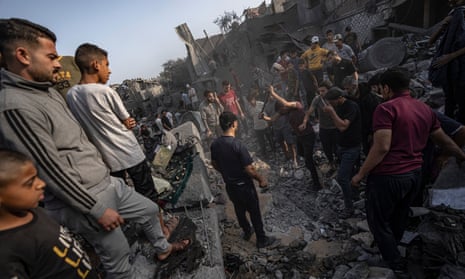 Palestinians look for survivors of the Israeli bombardment in the Maghazi refugee camp in the Gaza Strip, Sunday, Nov. 5, 2023. (AP Photo/Fatima Shbair)
