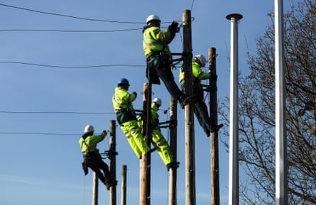 Trainee engineers from BT Openreach carry out work at the top of telegraph poles