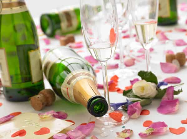 Empty wine bottles among rose petals