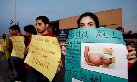 A woman holds a sign that says ‘Stop now’ during a protest against child sexual abuse in Asunción in 2015 after a 10-year-old was denied an abortion under laws which ban it except when the mother’s life is in danger.