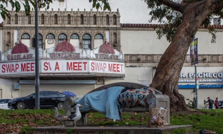 A unhoused person sleeps at MacArthur Park in Los Angeles in 2020.