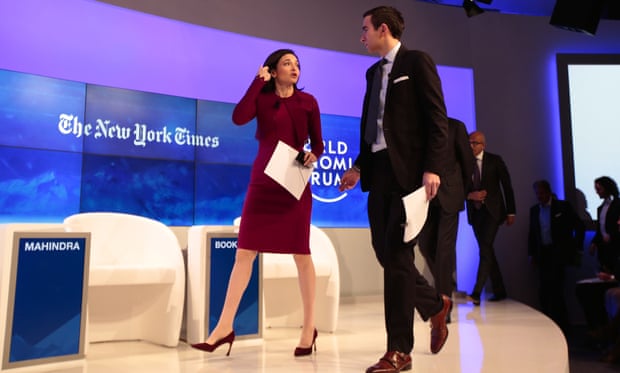 Sheryl Sandberg and New York Times journalist Andrew Ross Sorkin arrive at the World Economic Forum in Davos on 20 January 2016.