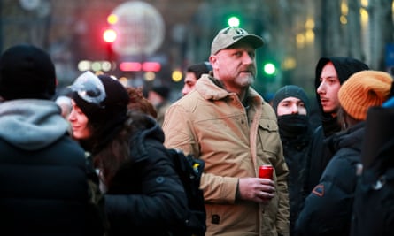 Zura Japaridze standing among a crowd while holding a canned drink