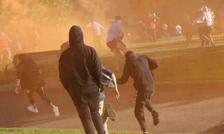Demonstrators react after police fire teargas around Melbourne’s Shrine of Remembrance