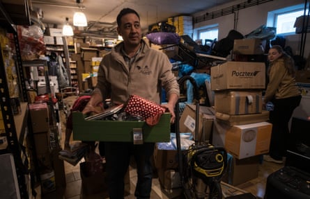 Don Seehafer carries a box of items.