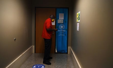 A Harris county employee walks inside the downtown Harris county clerk’s office, which was banned from serving as a mail ballot drop-off site after Governor Greg Abbott issued an order limiting each Texas county to one mail ballot drop-off site, in Houston, Texas.