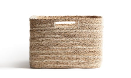 A large handmade seagrass storage basket on a white background
