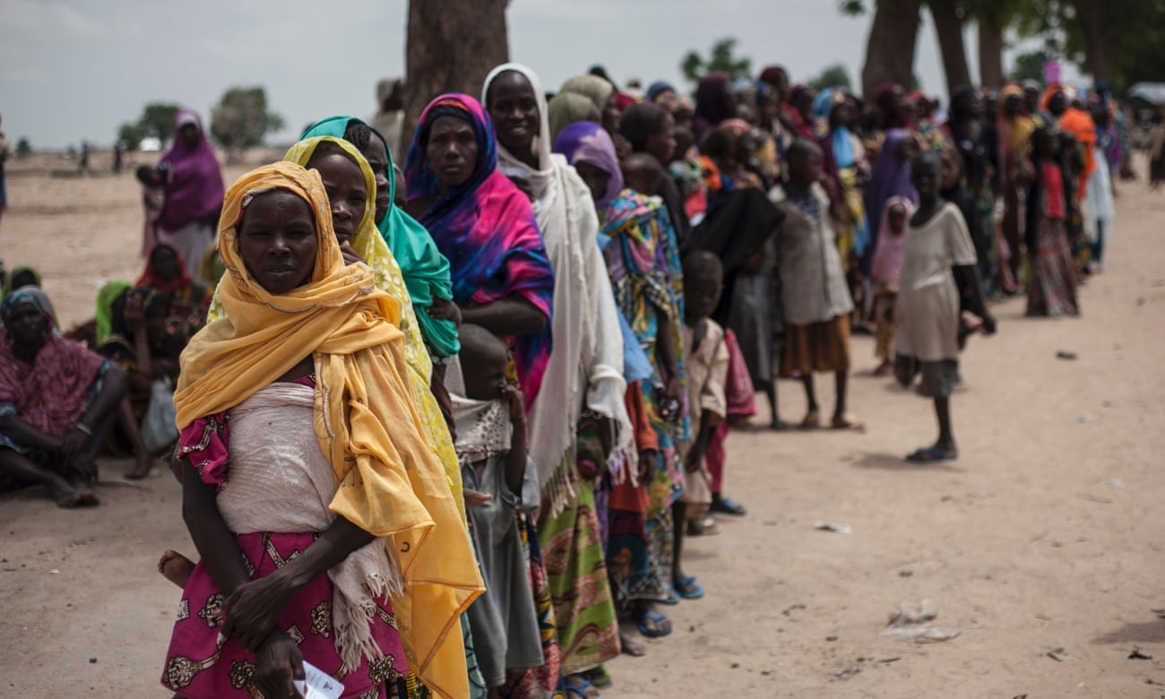 Women and children queue outside a Unicef nutrition clinic in a makeshift settlement in Muna, Maiduguri