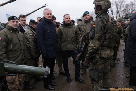 Lithuanian president Gitanas Nausėda (C-L) and Polish [resident Andrzej Duda (C) listen to a German soldier at a display during the Nato Dragon 24 military exercise on 5 March.