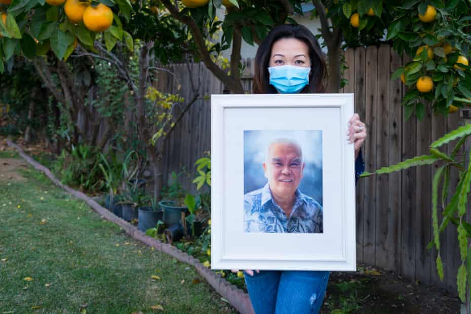 Dinh Kozuki holds the photograph of her father, Thong Nguyen, that was displayed during his memorial in August.