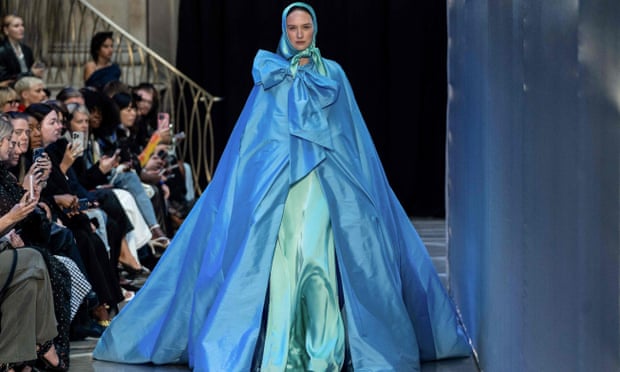Model in cornflower blue cloak and mint silk headscarf.