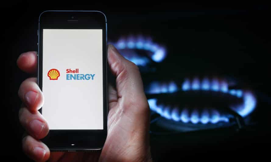 A man looks at the logo of the energy company Shell Energy's website on his phone