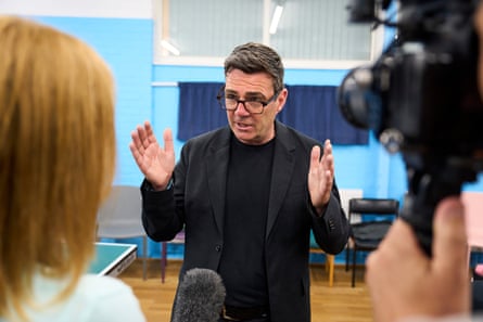 Burham gestures as he gives an interview
